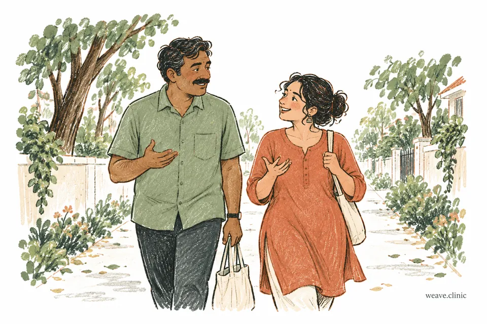 Two adults walking and talking along a tree-lined neighbourhood path